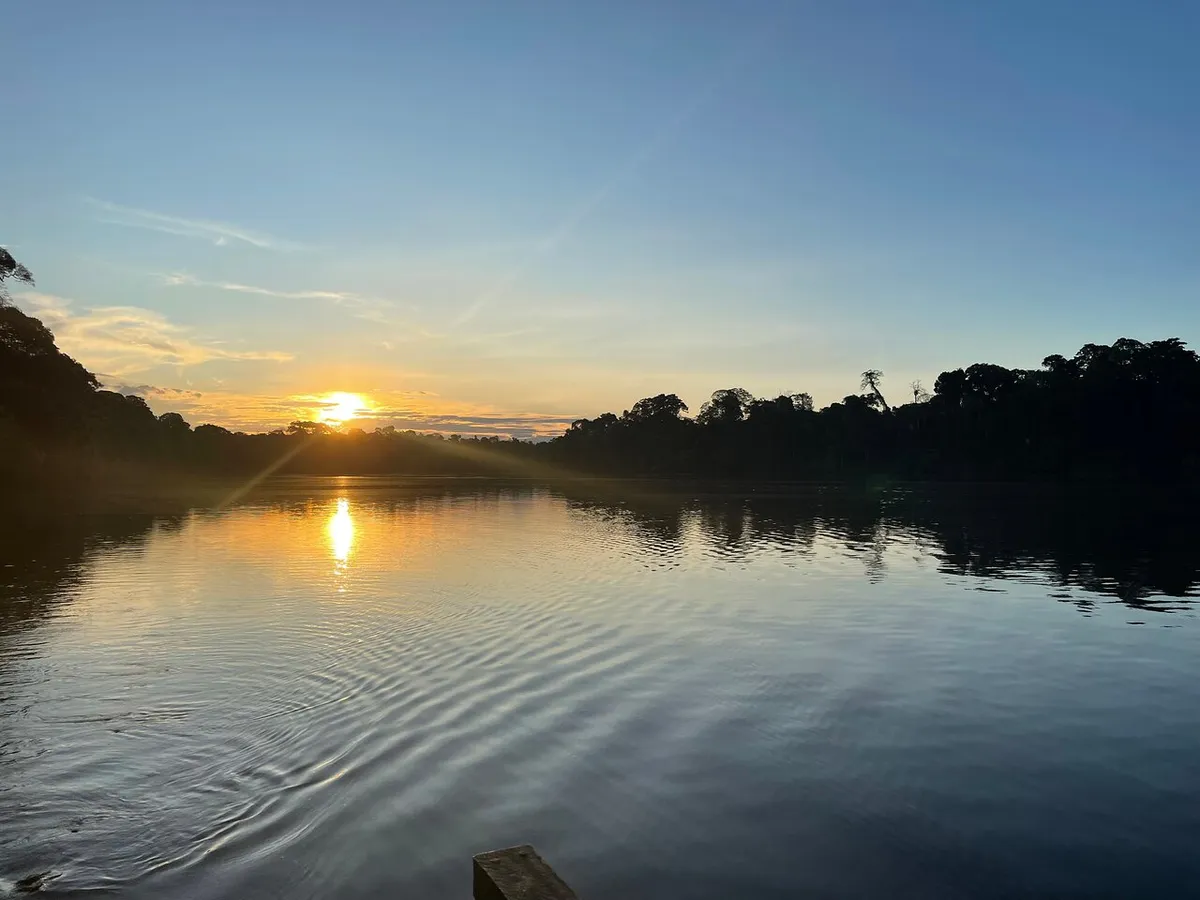 Sunrise over the Madre de Dios River from the lodge landing on a 4-day Puerto Maldonado Amazon tour, Peru